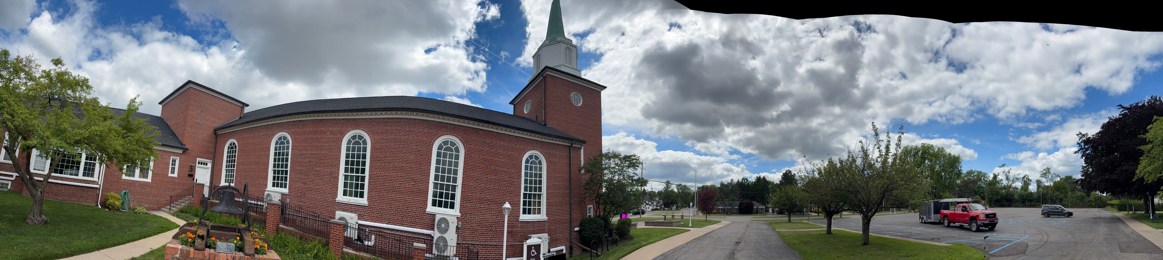 Copper gutters and downspout on historic church with arched windows